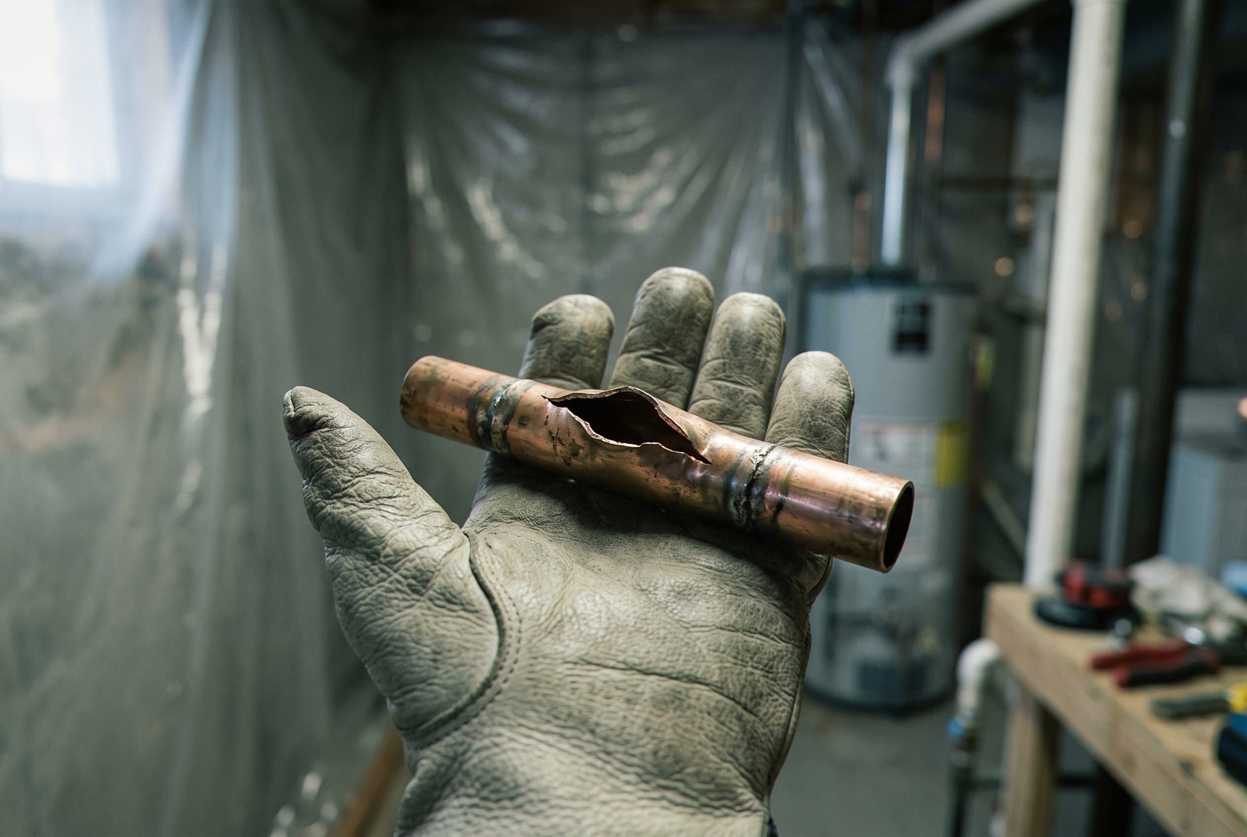 Close-up of pipe break and water damage